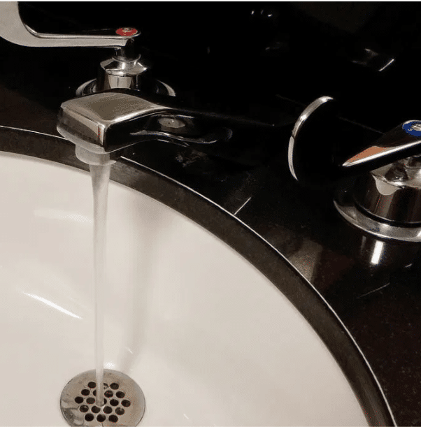 Plumber performing drain cleaning services