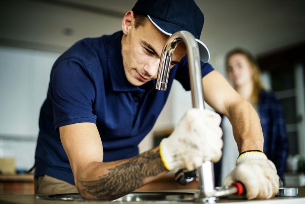 plumber fixing a kitchen sink